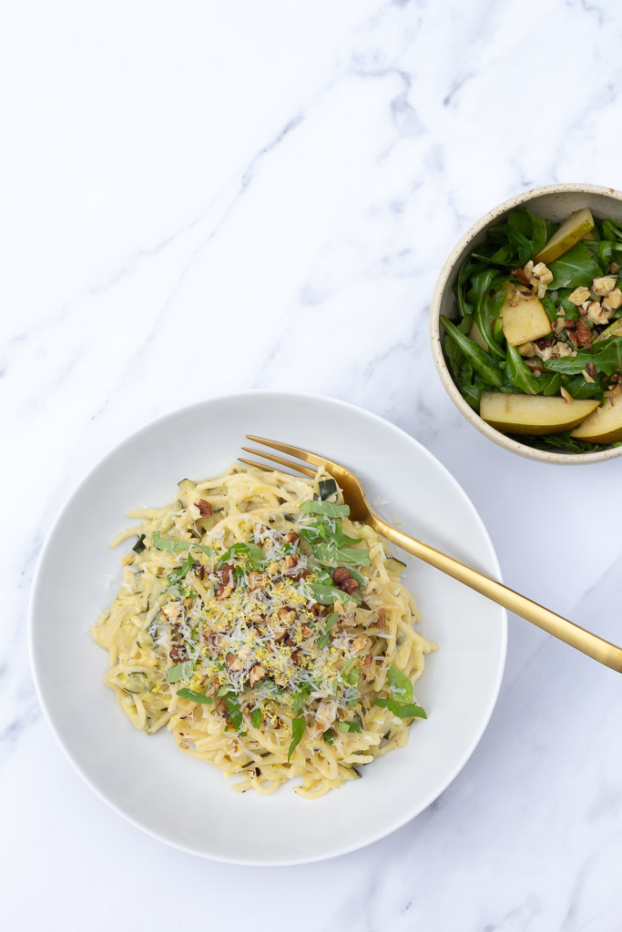 Cremet vegetarisk pastaret med citron og squash serveret med pære-rucolasalat