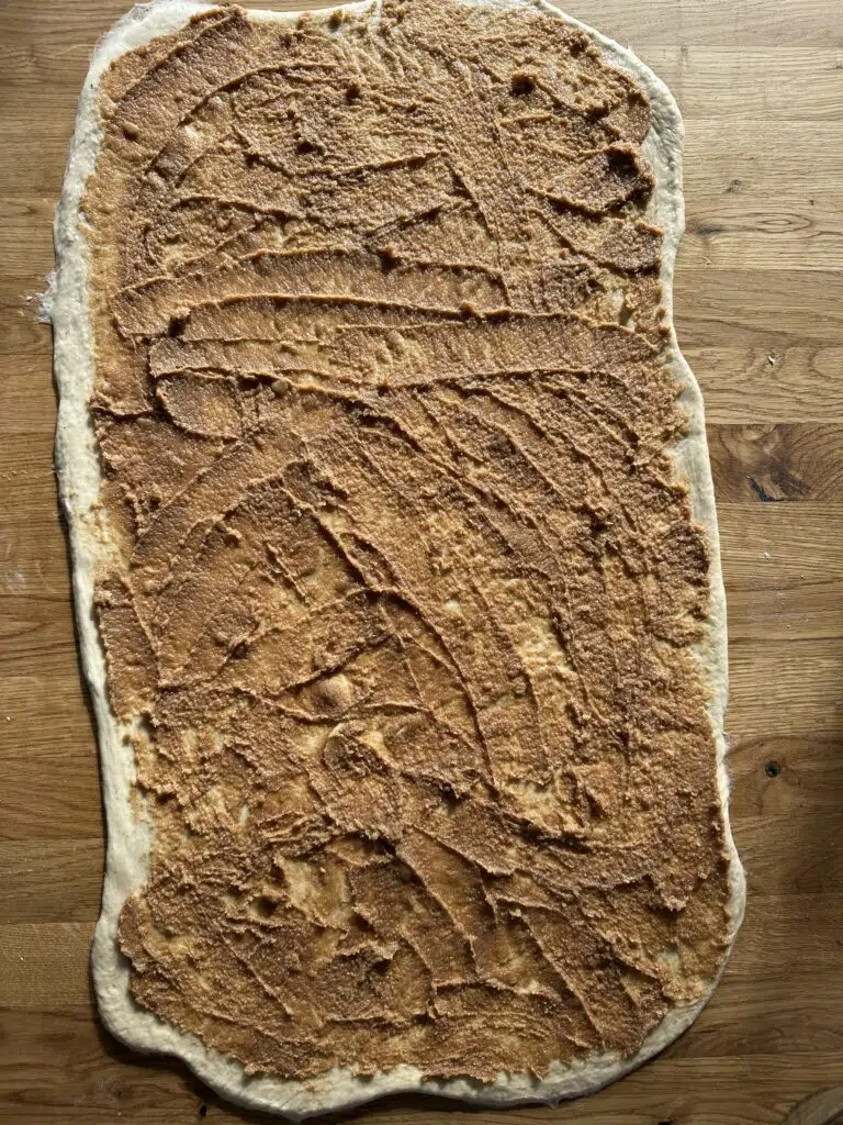 Dej udrullet til kanelsnurrer med æble med remonce smurt på